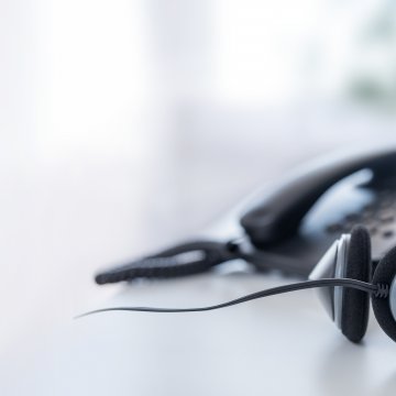 features voip service axvoice voip phone and headset on desk office